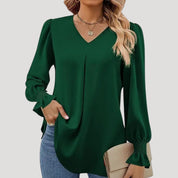 Blusa con cuello en V y mangas largas abullonadas: estilo elegante para la oficina. 0