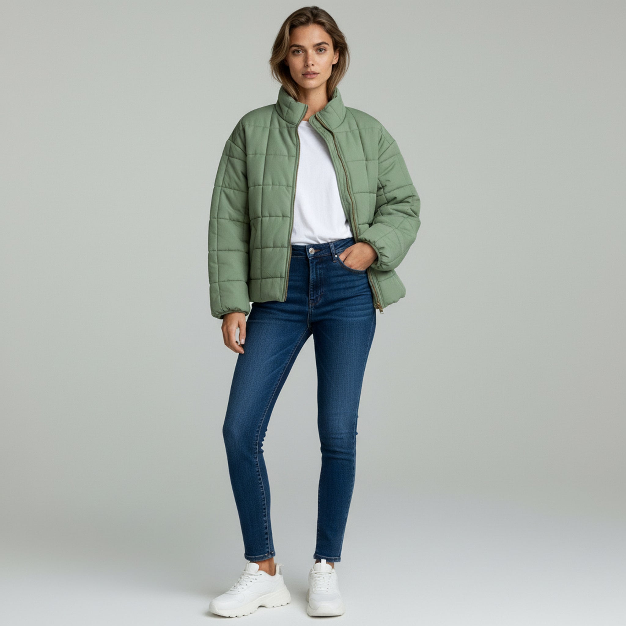 lady in green padded jacket and pants on a plain background