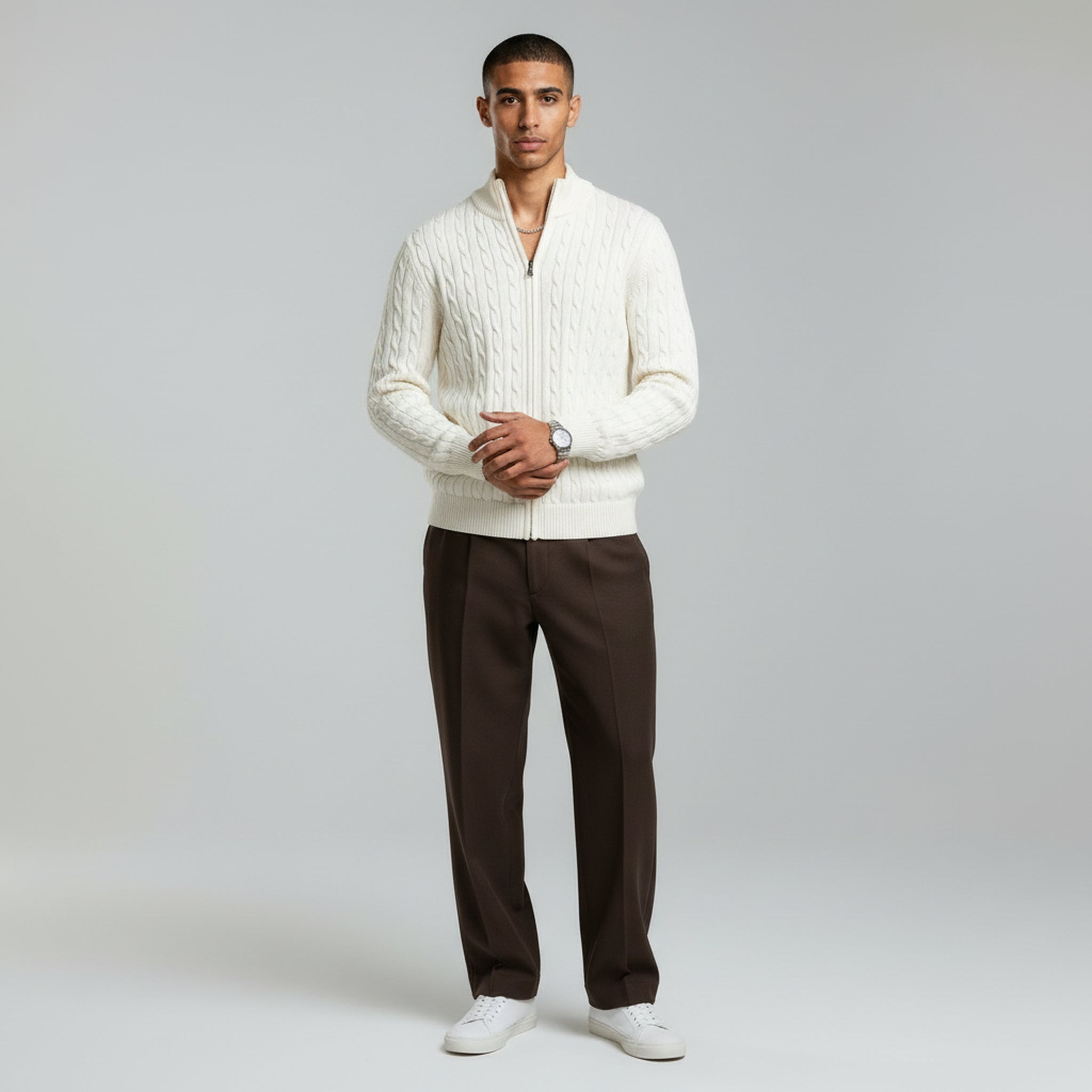 man wearing zipped white sweater on a plain background